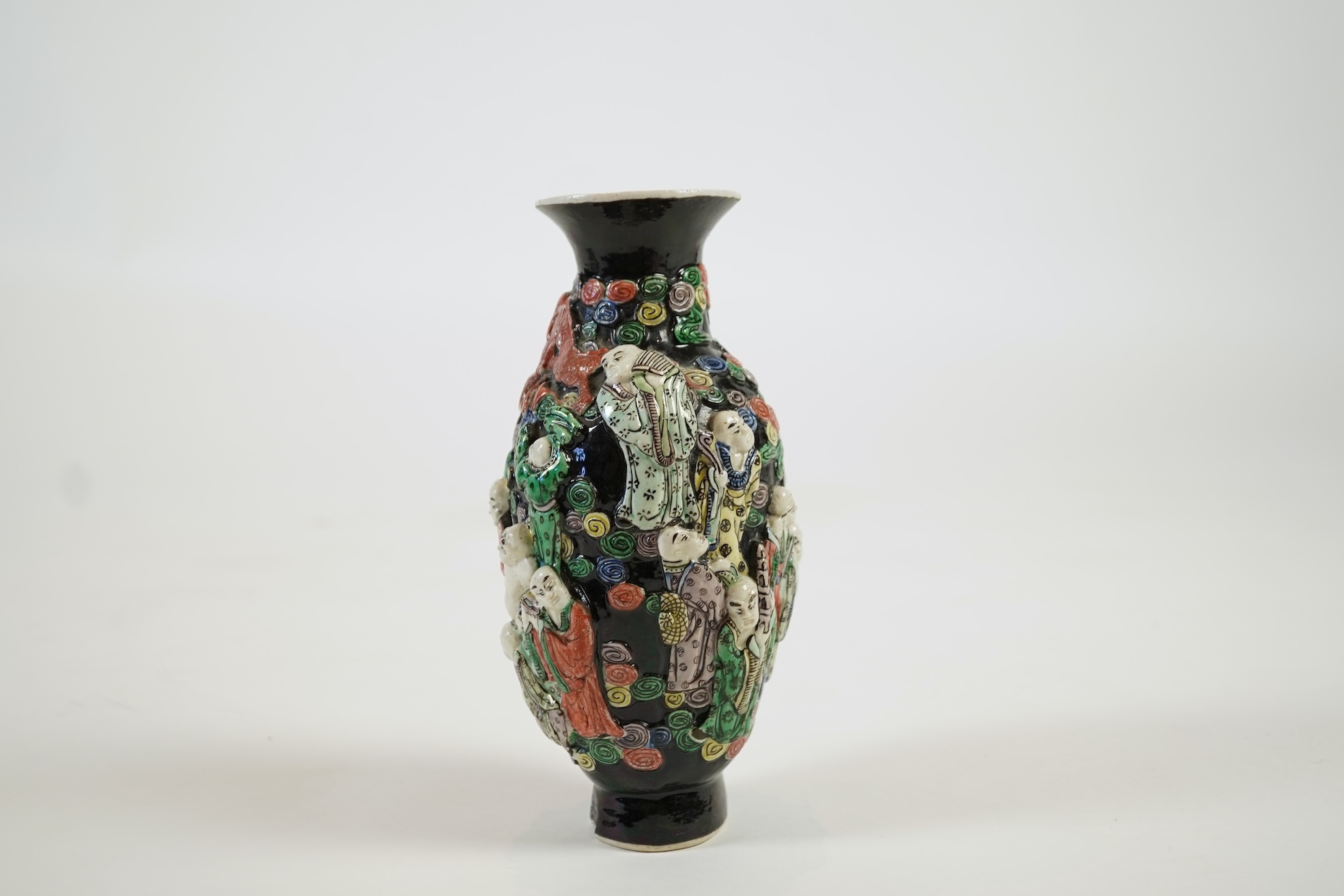 A Chinese enamelled biscuit ‘eighteen Luohan’ vase, 19th century